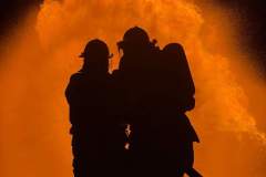 Silhouetted group against dramatic fire backdrop — propane emergency training 2023