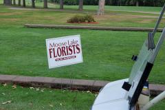 Florists sign on manicured lawn — golf scramble fundraiser 2023