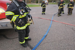 Firefighter operating hose — propane burn training November 2025
