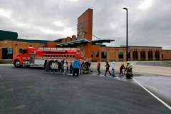 Fire truck parked in front of modern brick building — fire prevention 2023