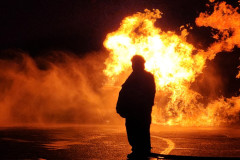 Silhouetted firefighter against massive explosion — propane burn training November 2025