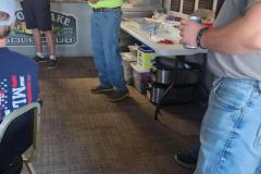 Indoor gathering in garage — golf scramble fundraiser 2023