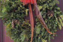Green wreath with evergreen branches and pinecones — grateful community member