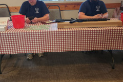 Two people at registration table — golf scramble fundraiser September 2025