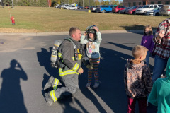 Firefighter in yellow gear — fire prevention October 2024