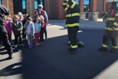Children watching firefighters — fire prevention 2025