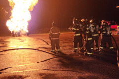 Firefighters conducting nighttime propane burn training November 2025