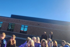 Group gathered in front of brick building — fire prevention October 2024