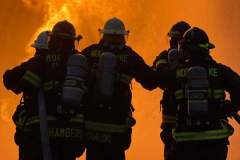Silhouettes of three firefighters against fire — propane emergency training 2023