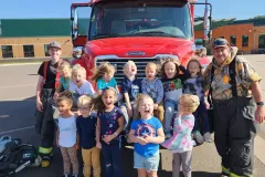 Group of children and adults in front of fire truck — fire prevention Moose Lake School 2022