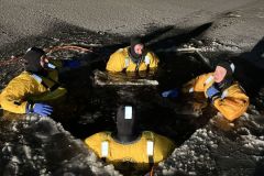Group in yellow and black safety gear on ice — ice rescue 2024