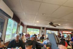 Indoor gathering at golf scramble fundraiser September 2025