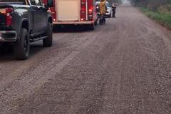 Rural dirt road with two vehicles — County Road 11 wildland fire 2023