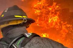 Firefighter in black helmet and gear — kitchen fire May 2024