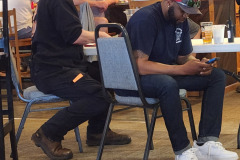 People seated at table — golf scramble fundraiser September 2025