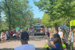 Fire truck surrounded by crowd at Fourth of July Parade 2025