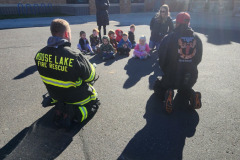 First responders gathered in circle — fire prevention 2025