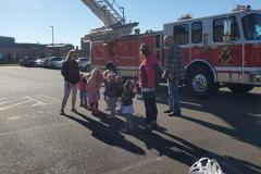 Group gathered near red fire truck — fire prevention 2020