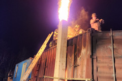 Illuminated brick building at night — chimney fire training February 2024